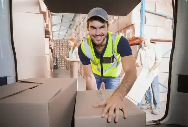 Delivery driver loading his van with boxes outside the warehouse-1